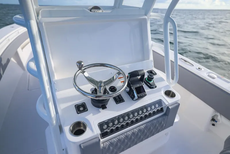 Slide: The Image of 2025 Invincible 33 Open Fisherman boat console with steering wheel and controls. - 19