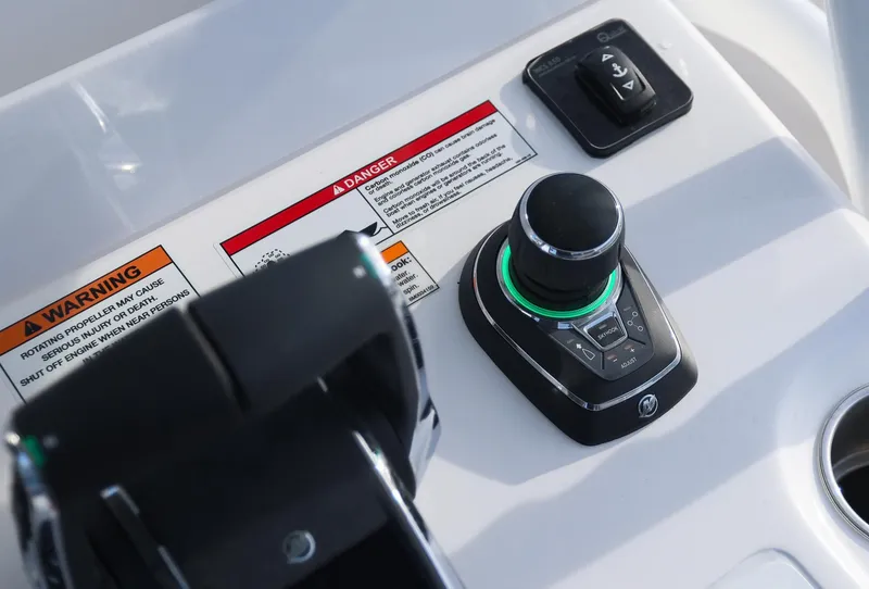 Slide: The Image of 2025 Invincible 33 Open Fisherman boat controls with warning labels and joystick. - 20