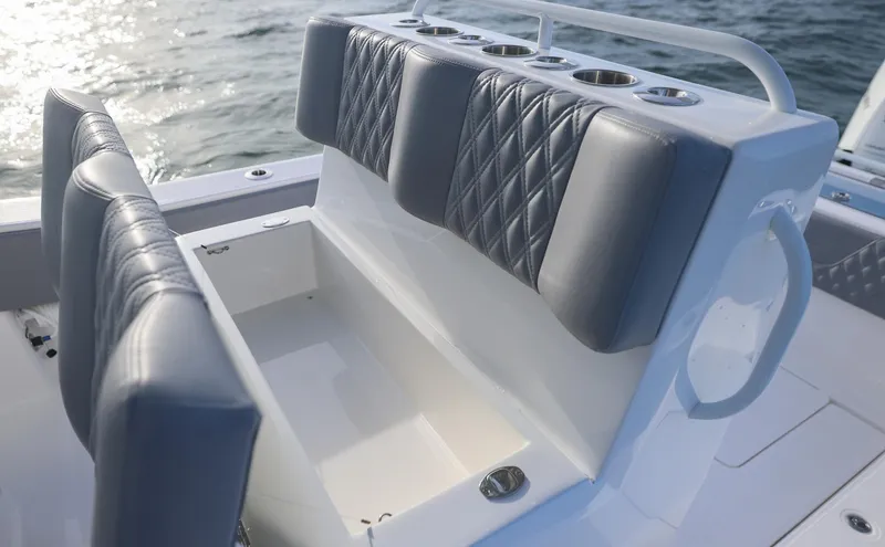 Slide: The Image of 2025 Invincible 33 Open Fisherman boat seating with quilted cushions on the water. - 21