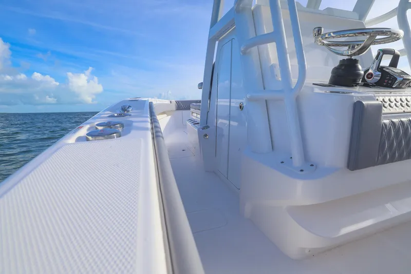 Slide: The Image of 2025 Invincible 33 Open Fisherman boat on open water, showcasing sleek design and modern features. - 34