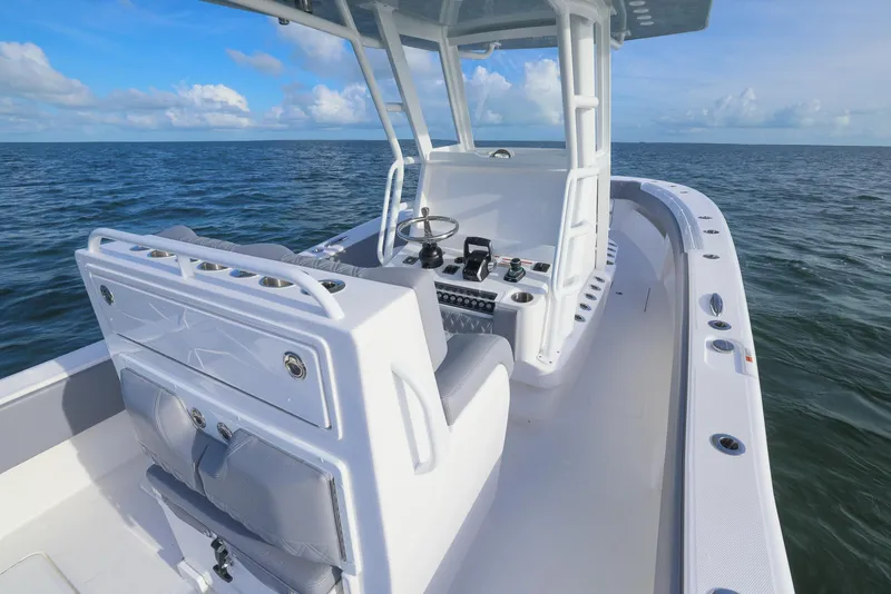Slide: The Image of 2025 Invincible 33 Open Fisherman boat on open water, showcasing helm and seating area. - 36