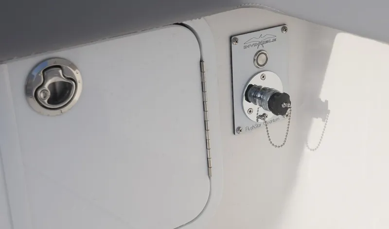 Slide: The Image of 2025 Invincible 33 Open Fisherman boat detail, featuring a fuel cap and electrical connection. - 37