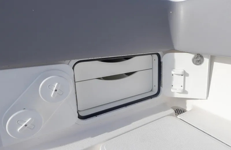Slide: The Image of 2025 Invincible 33 Open Fisherman storage compartment with white interior. - 38