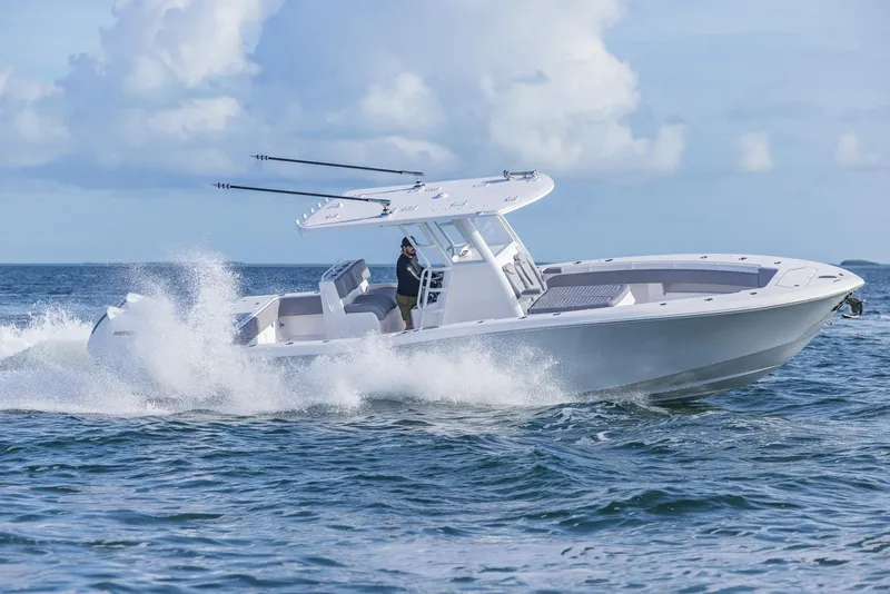 Slide: The Image of 2025 Invincible 33 Open Fisherman boat cruising on ocean waves. - 49