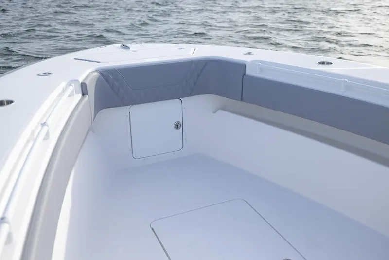 Slide: The Image of 2025 Invincible 33 Open Fisherman boat interior with cushioned seating and storage. - 7
