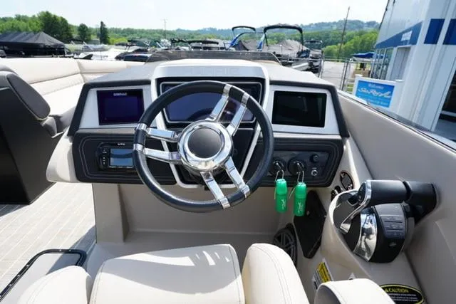 Slide: The Image of 2019 Harris Crowne 270 SL Twin Engine boat dashboard with steering wheel and controls. - 10