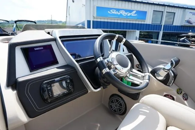 Slide: The Image of 2019 Harris Crowne 270 SL Twin Engine boat dashboard with steering wheel and controls. - 11