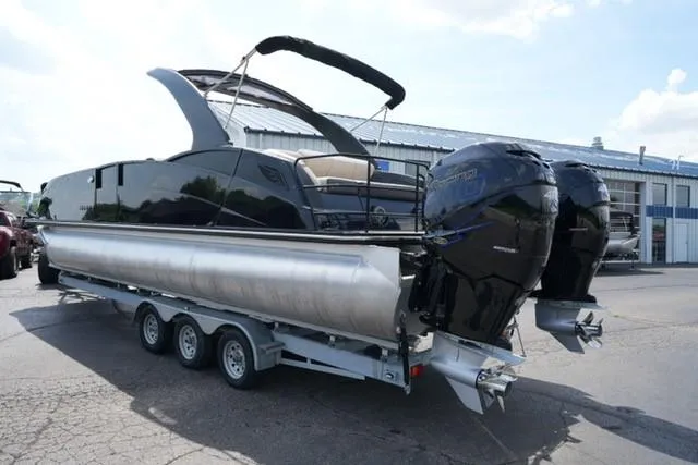Slide: The Image of 2019 Harris Crowne 270 SL Twin Engine pontoon boat on trailer, parked outdoors. - 5