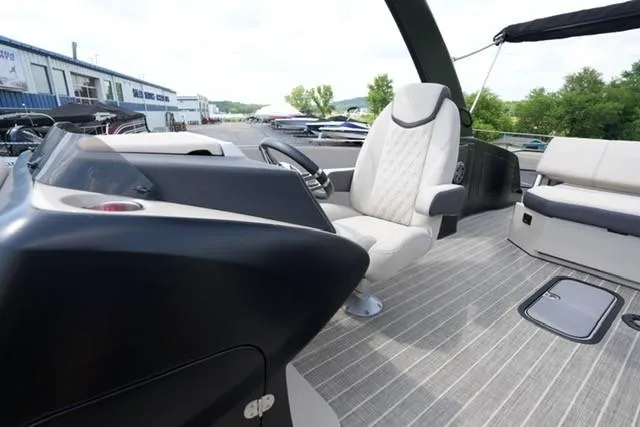Slide: The Image of 2019 Harris Crowne 270 SL Twin Engine boat interior with captain's chair and control panel. - 8