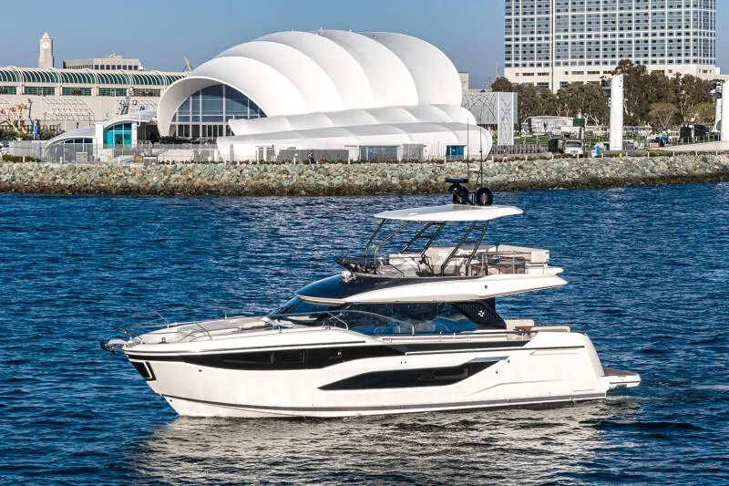 Slide: The Image of Luxurious 2025 Prestige F4.9 yacht cockpit with marina view, featuring modern controls and seating. - 12