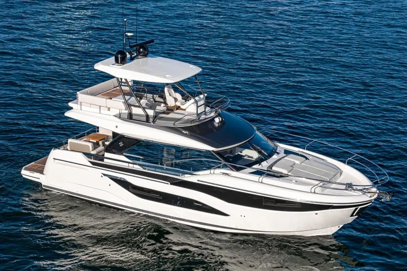 Slide: The Image of Prestige F4.9 yacht interior, featuring open storage compartment and wooden steps, 2025 model. - 19