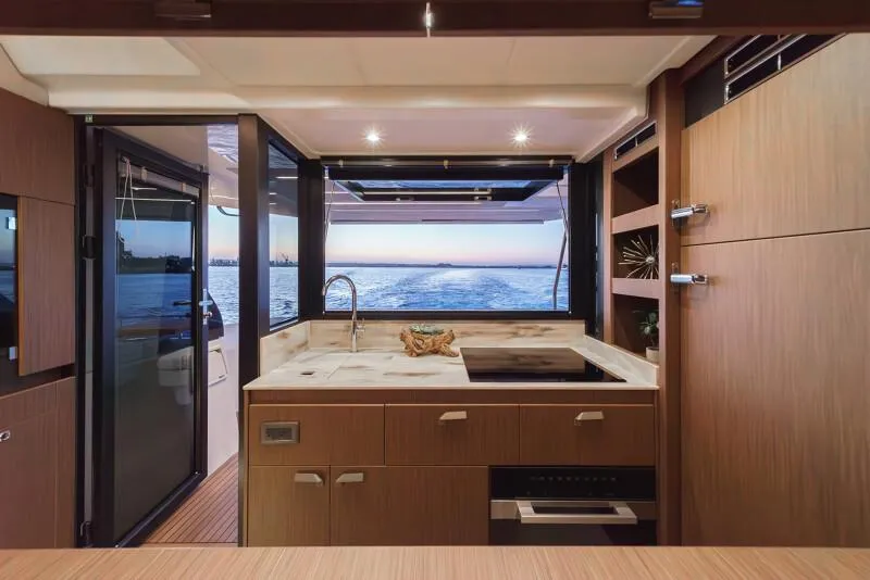 Slide: The Image of 2025 Prestige F4.9 yacht cruising in a harbor with industrial background. - 50