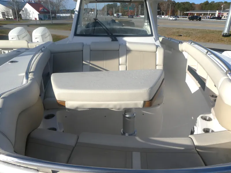 Slide: The Image of 2024 Boston Whaler 350 Realm boat interior with seating and table. - 16