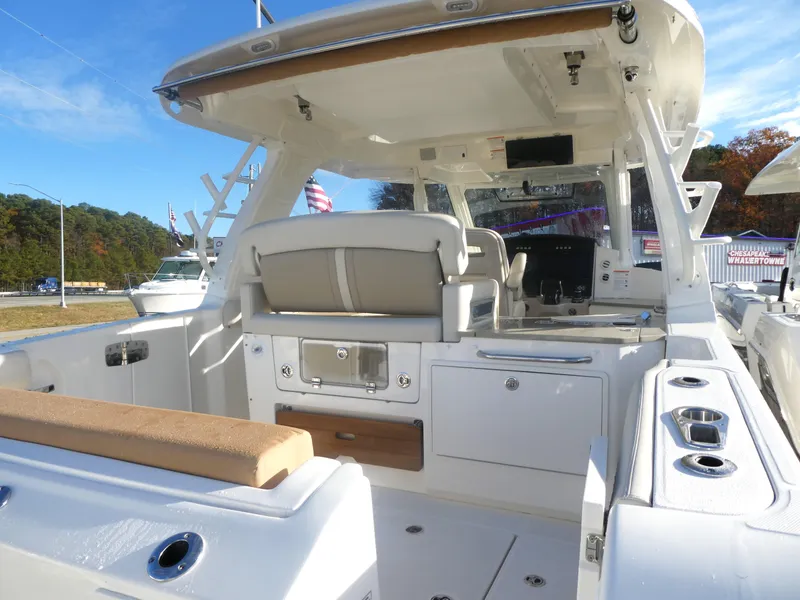 Slide: The Image of 2024 Boston Whaler 350 Realm boat interior with seating and helm station. - 5