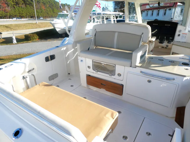 Slide: The Image of 2024 Boston Whaler 350 Realm boat interior with seating and storage compartments. - 6
