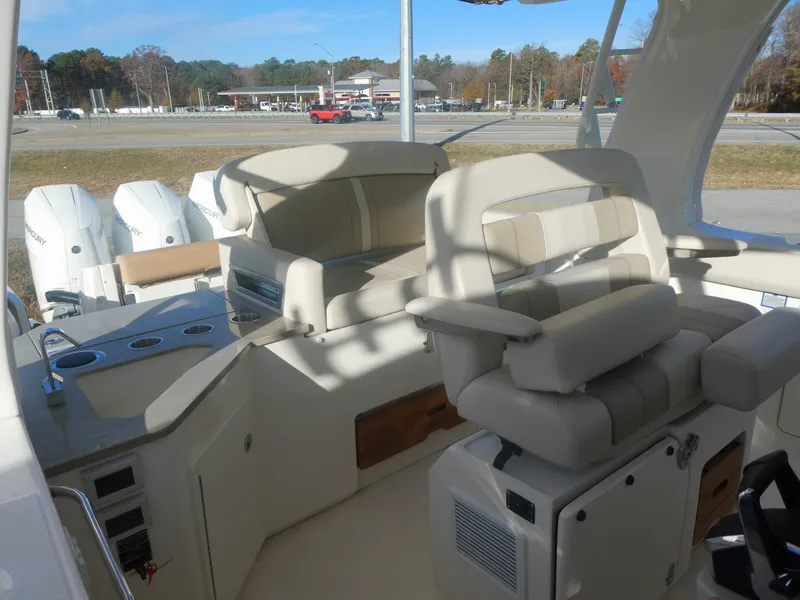 Slide: The Image of 2024 Boston Whaler 350 Realm interior with plush seating and modern design. - 7