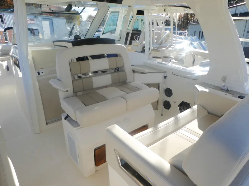 Slide: The Image of 2024 Boston Whaler 350 Realm interior with luxurious seating and modern design. - 8