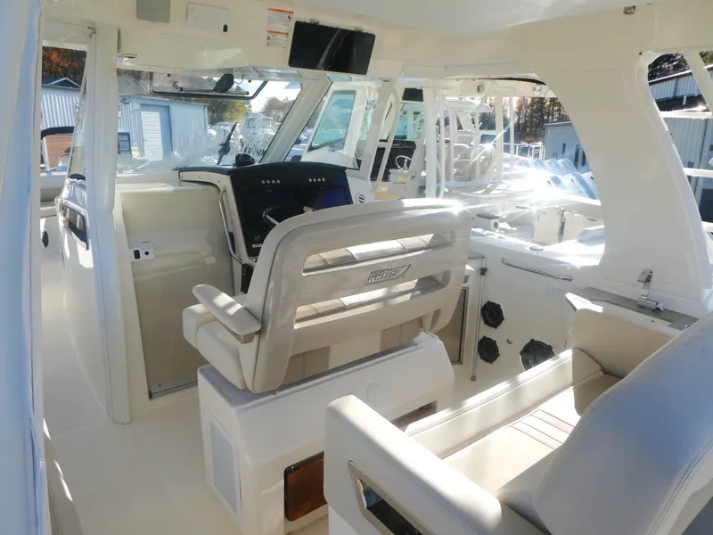 Slide: The Image of 2024 Boston Whaler 350 Realm interior with modern helm and seating. - 9