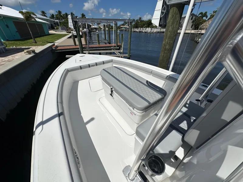 Slide: The Image of 2024 Lake & Bay 25 Open boat docked by a waterfront home. - 14