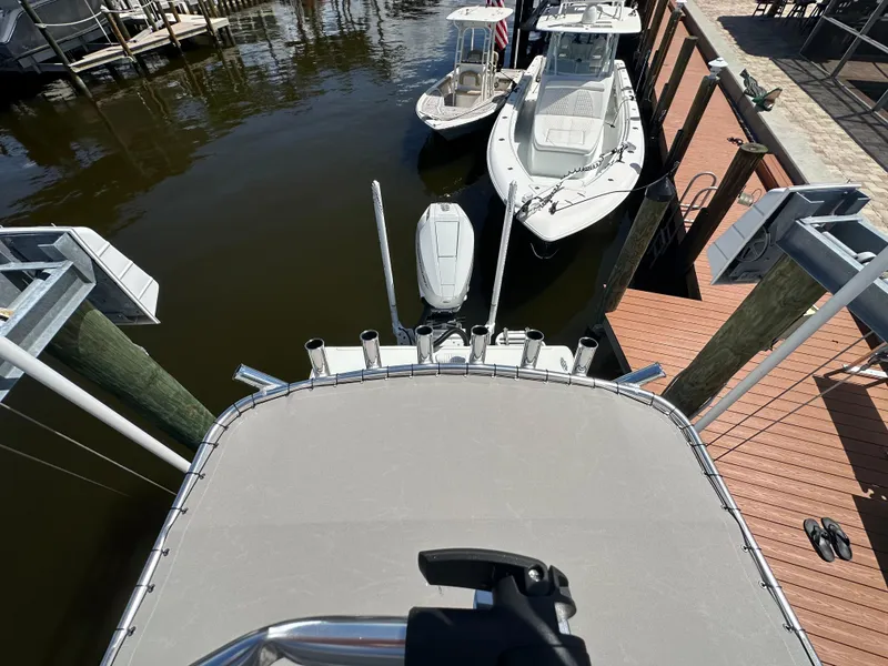 Slide: The Image of 2024 Lake & Bay 25 Open boat docked at marina, aerial view. - 18