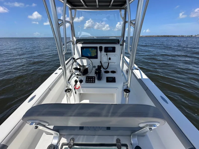 Slide: The Image of 2024 Lake & Bay 25 Open boat interior with steering console on open water. - 20
