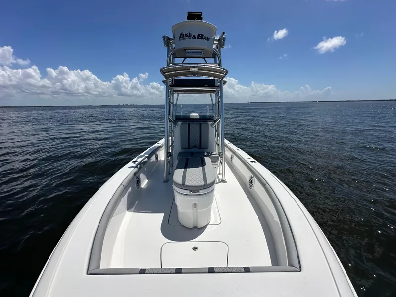 Slide: The Image of 2024 Lake & Bay 25 Open boat on calm water under clear sky. - 21