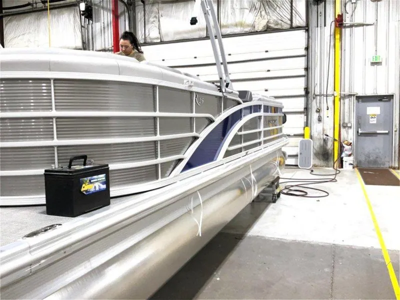 Slide: The Image of 2024 Bennington 25 RSR pontoon boat in a warehouse setting. - 11
