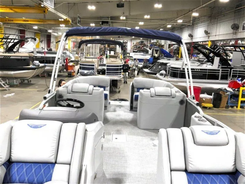 Slide: The Image of 2024 Bennington 25 RSR pontoon boat interior in a manufacturing facility. - 3