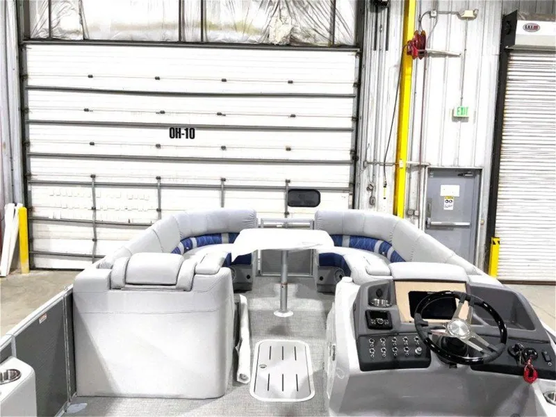 Slide: The Image of 2024 Bennington 25 RSR pontoon boat interior with plush seating and modern helm. - 4