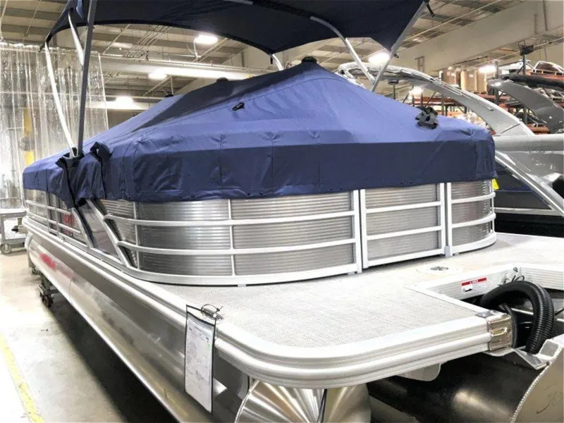 Slide: The Image of 2024 Bennington 25 RSR pontoon boat with blue cover in showroom. - 5