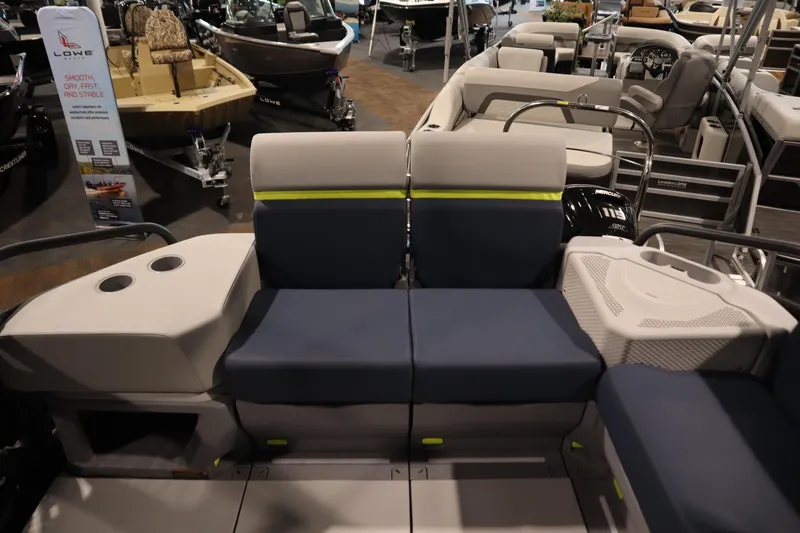 Slide: The Image of 2025 Sea-Doo Switch Cruise Limited 21 interior with blue and gray seating at a boat show. - 25