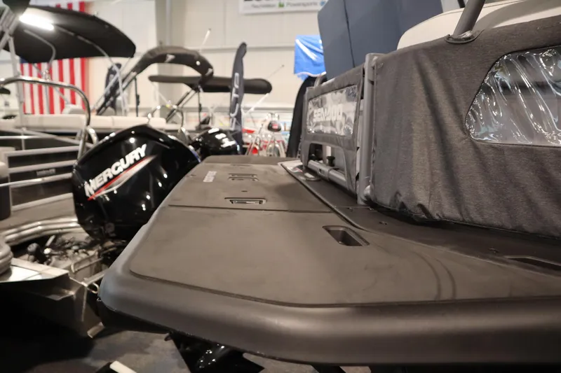 Slide: The Image of 2025 Sea-Doo Switch Cruise Limited 21 with Mercury engine, showcased indoors. - 30