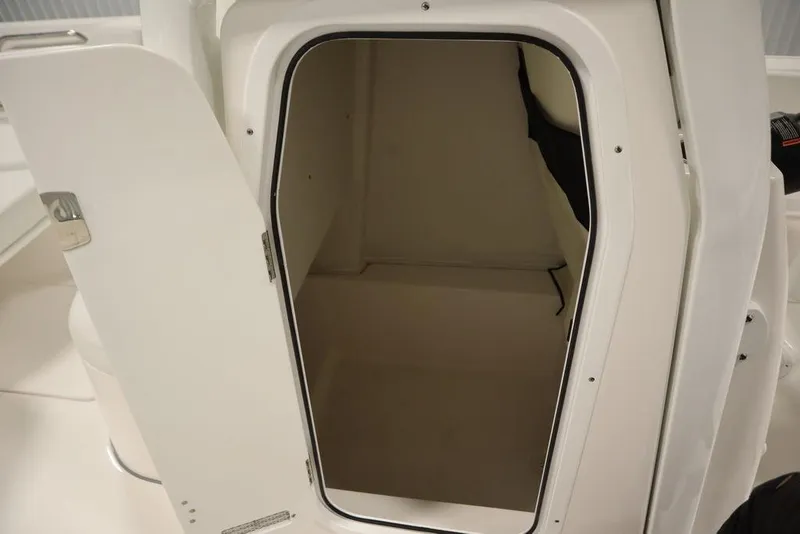 Slide: The Image of 2025 Sea Fox 248 Commander boat storage compartment with open door. - 24