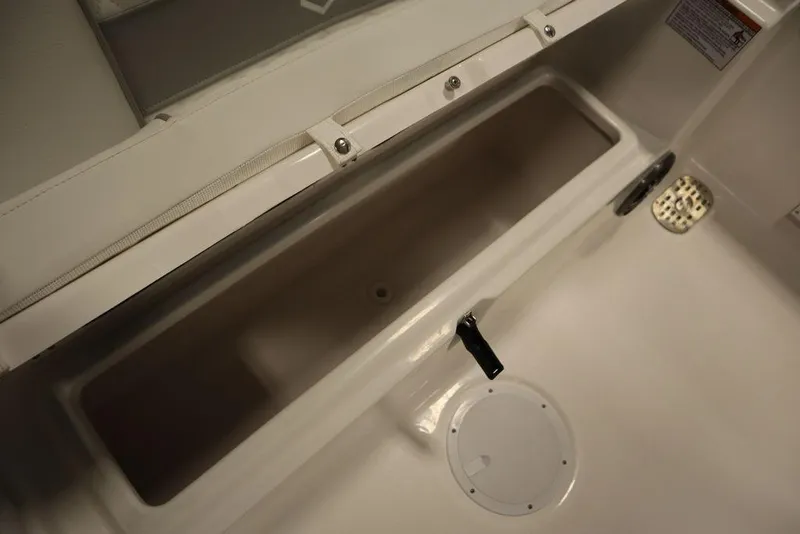 Slide: The Image of 2025 Sea Fox 248 Commander boat storage compartment with latch and drainage. - 44