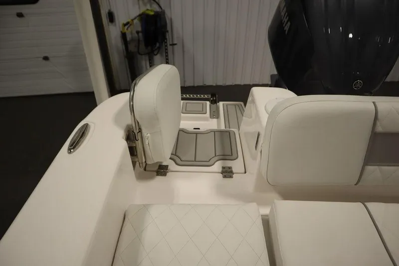 Slide: The Image of 2025 Sea Fox 248 Commander boat interior with white seating and engine view. - 46