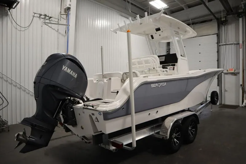Slide: The Image of 2025 Sea Fox 248 Commander boat with Yamaha engine in a garage. - 5