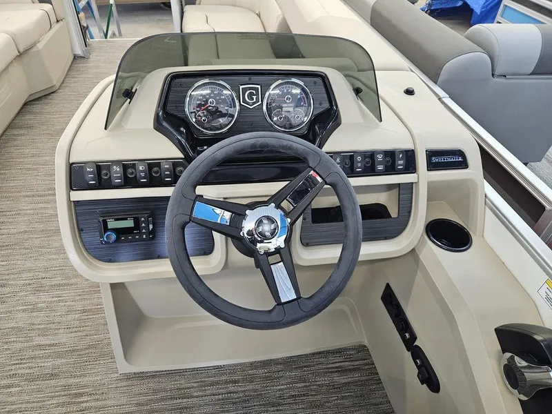 Slide: The Image of 2025 Godfrey SWEETWATER 2286 SB boat dashboard with steering wheel and controls. - 2