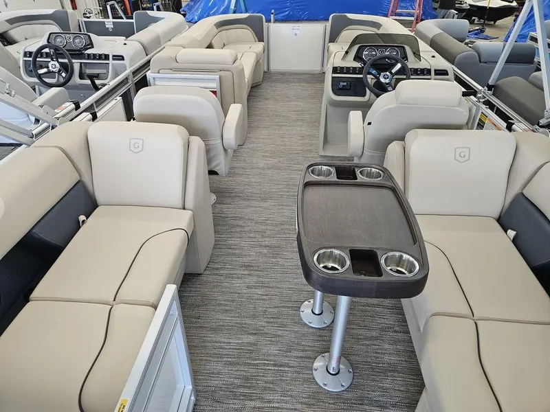 Slide: The Image of 2025 Godfrey SWEETWATER 2286 SB pontoon boat interior with beige seating and modern dashboard. - 4