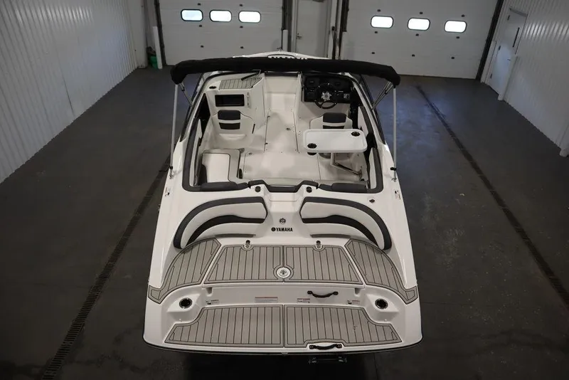 Slide: The Image of 2025 Yamaha Boats SX195 in a garage, showcasing sleek interior and modern design. - 11