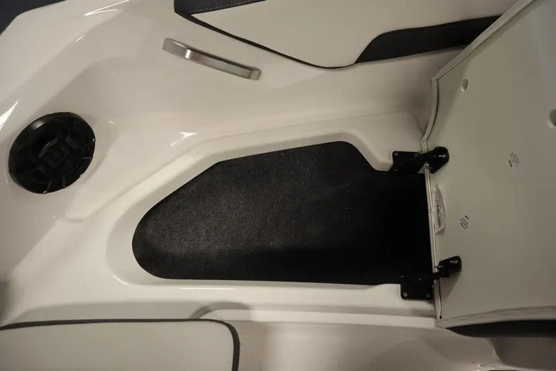 Slide: The Image of 2025 Yamaha Boats SX195 interior storage compartment with speaker and handle. - 18