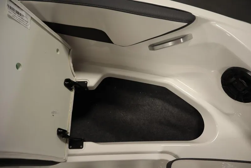 Slide: The Image of 2025 Yamaha Boats SX195 interior storage compartment with open hatch and sleek design. - 19