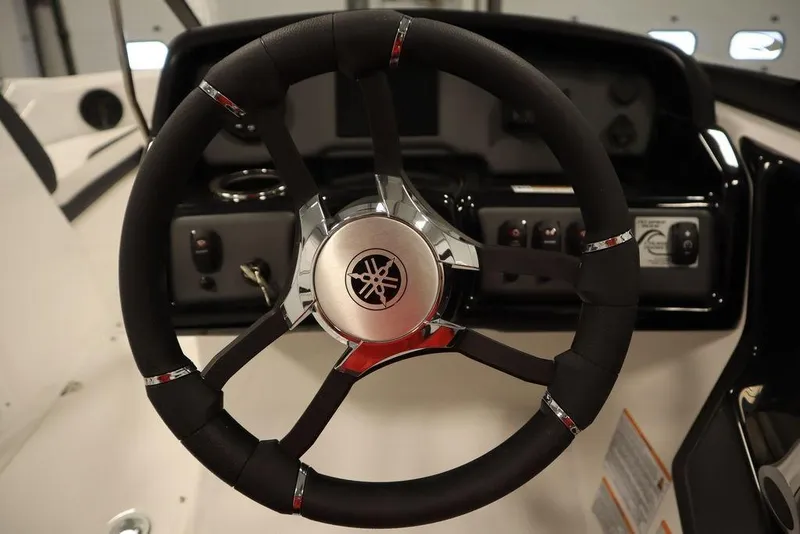 Slide: The Image of Steering wheel of 2025 Yamaha Boats SX195, featuring sleek design and control panel. - 23