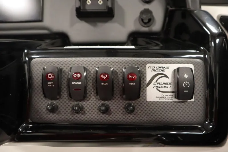 Slide: The Image of Control panel of 2025 Yamaha Boats SX195 featuring various switches and cruise assist. - 29