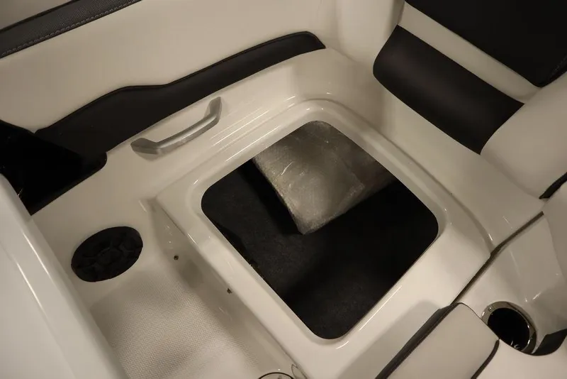Slide: The Image of 2025 Yamaha Boats SX195 interior storage compartment with sleek white and black seating. - 37