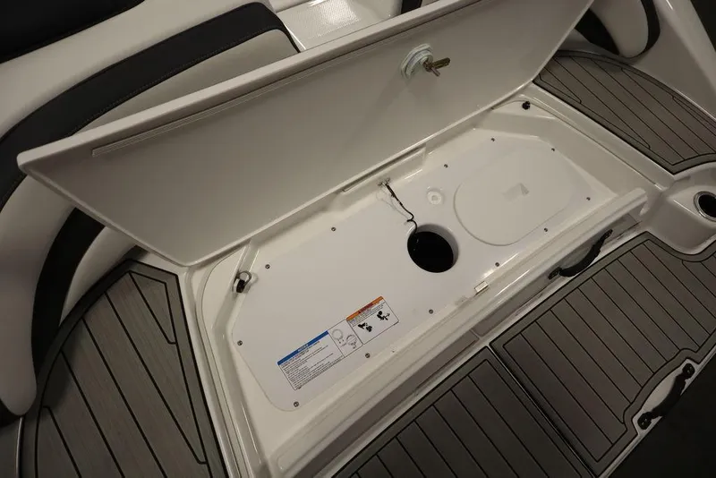 Slide: The Image of 2025 Yamaha Boats SX195 storage compartment with open lid, showcasing interior details. - 42