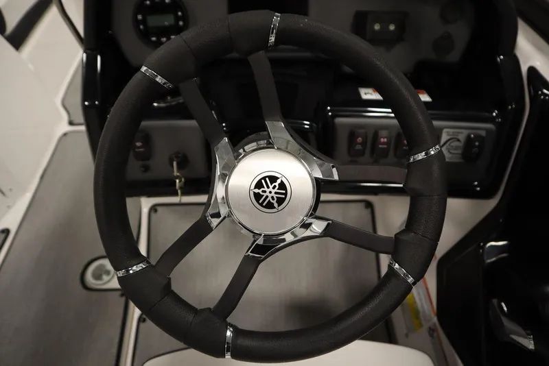 Slide: The Image of Steering wheel of 2025 Yamaha Boats SX195, featuring sleek design and control panel. - 10