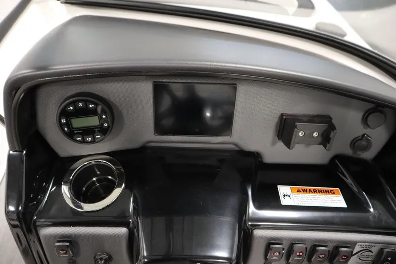 Slide: The Image of 2025 Yamaha Boats SX195 dashboard with controls, display, and warning label. - 15