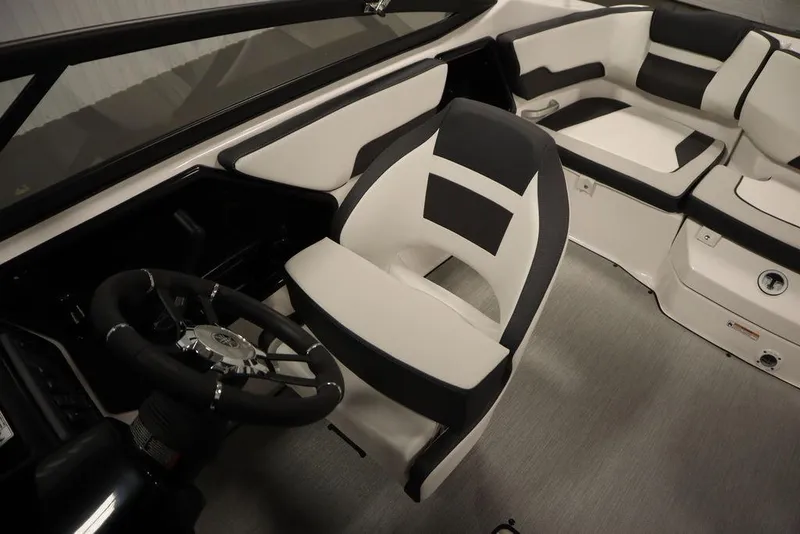 Slide: The Image of 2025 Yamaha Boats SX195 interior with sleek black and white seating and steering wheel. - 19