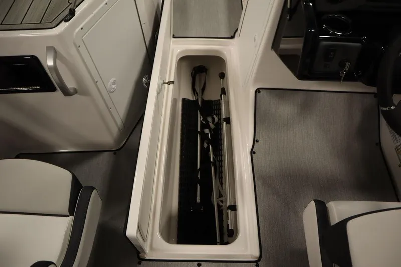 Slide: The Image of 2025 Yamaha Boats SX195 interior storage compartment with sleek design and ample space. - 21