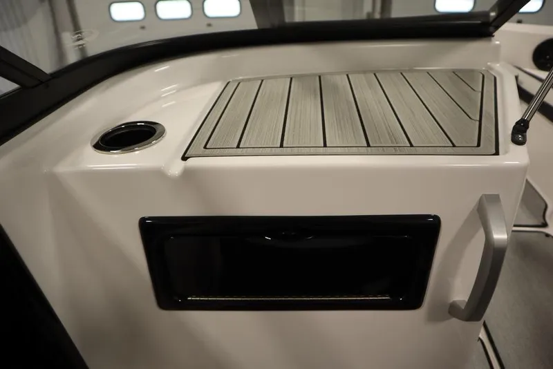 Slide: The Image of 2025 Yamaha Boats SX195 interior detail with sleek design and cup holder. - 23